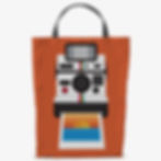 Orange shopping bag with vintage instant camera ejecting sunset photo