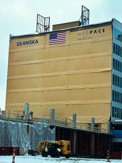 multi story building wrapped in temporary enclosure system for healthcare construction