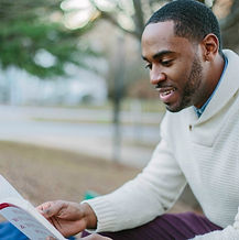 Enjoying fresh air while sitting in the park captivated by the content in his book. Reading mind, stirs the soul, comfo
