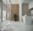 Modern Interior Design of a dental office in Florida with marble reception desk, textured wooden panel, and large windows.