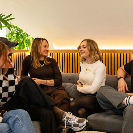 Group of colleagues chatting on a sofa