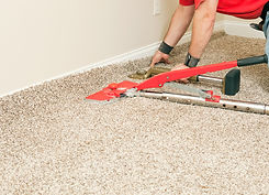 Carpet stretching tool on beige carpet