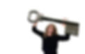 Kara looking messy holding up a giant key