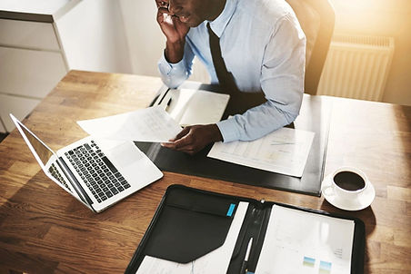 Business man working on his phone at a desk