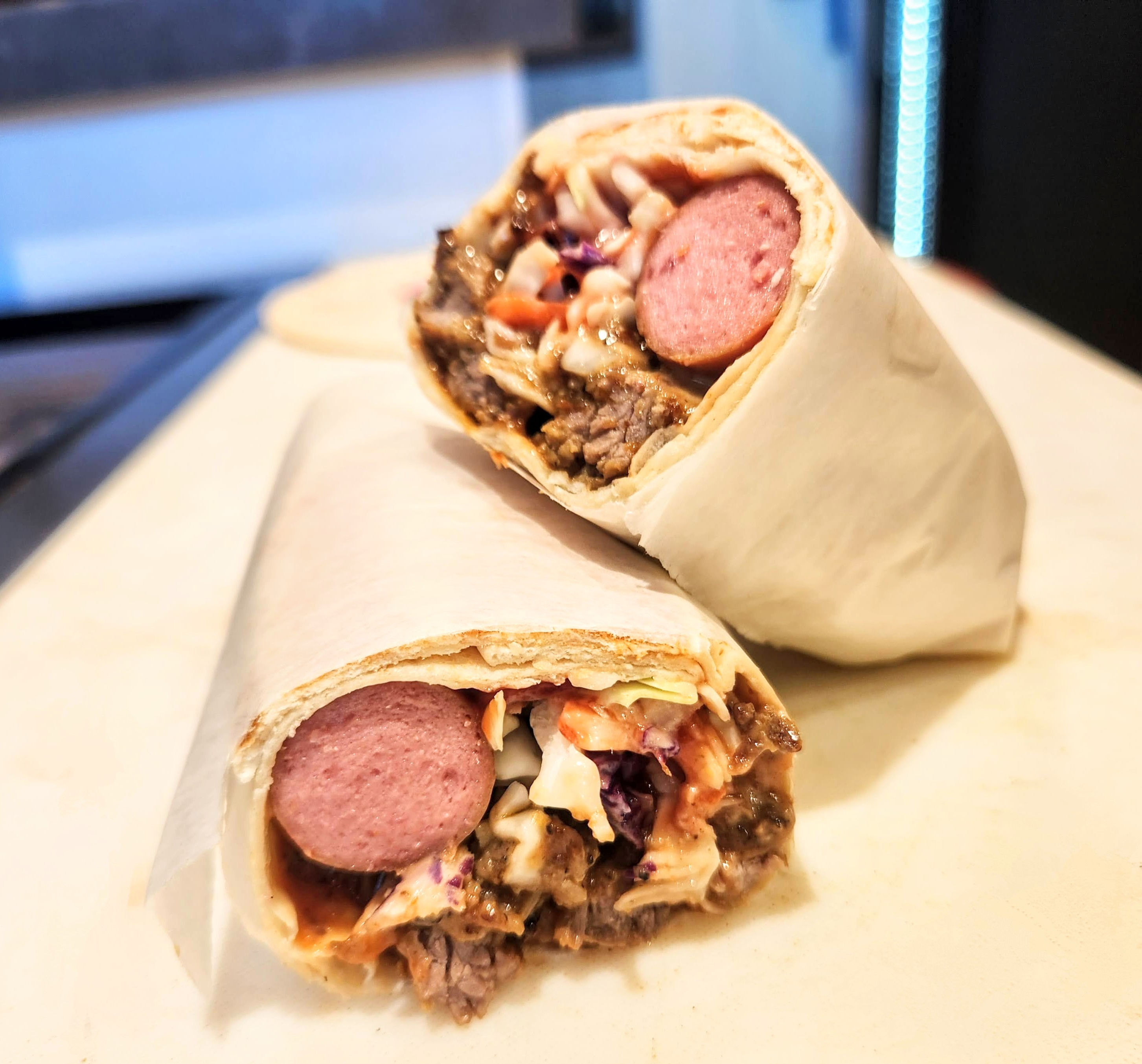 Buff shawarma wrap with grilled beef, hot dog slices, and creamy slaw