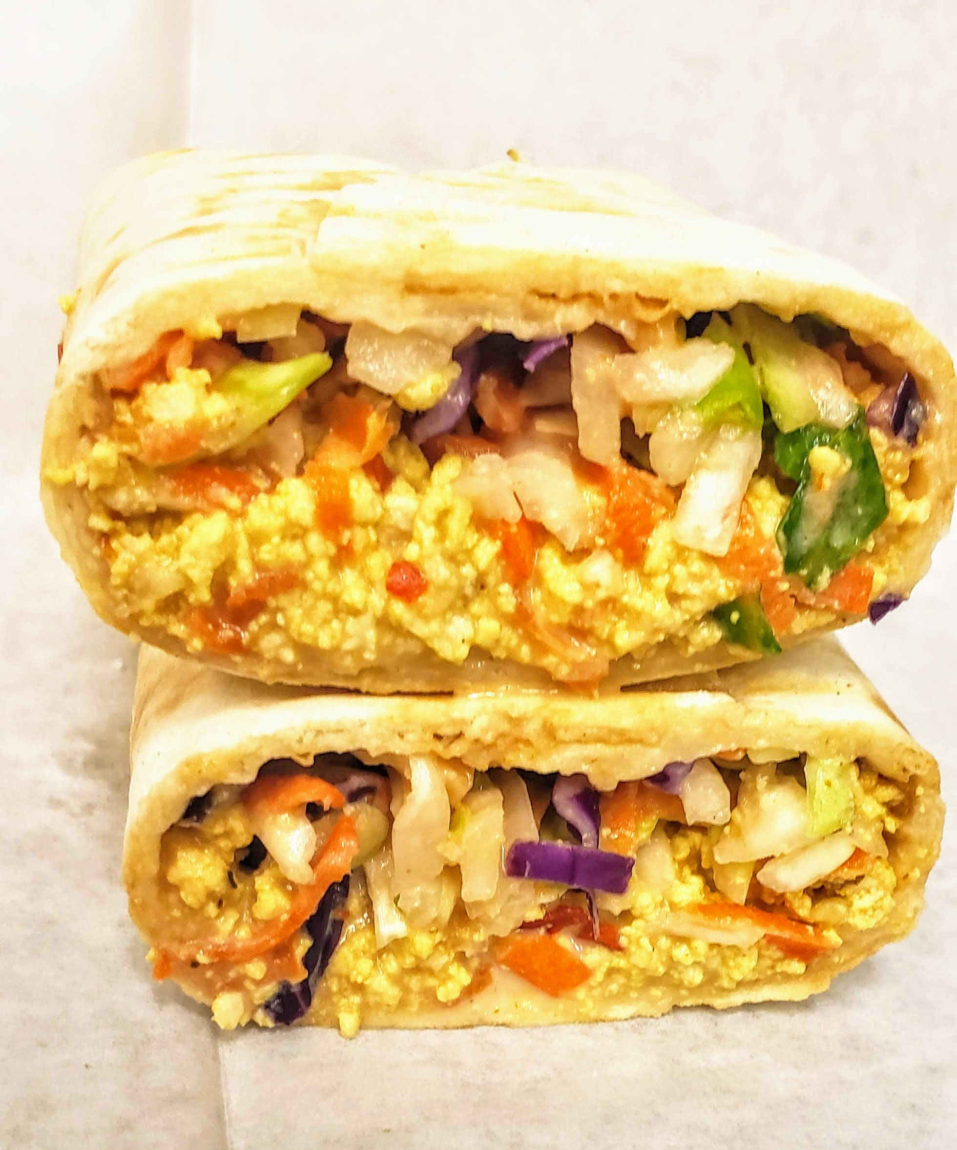 Vegan tofu buff shawarma wrap with slaw and creamy Nigerian sauce