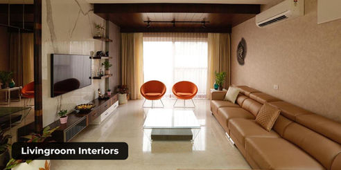 Spacious living room interior with neutral sofa, modern wall décor, and natural light.