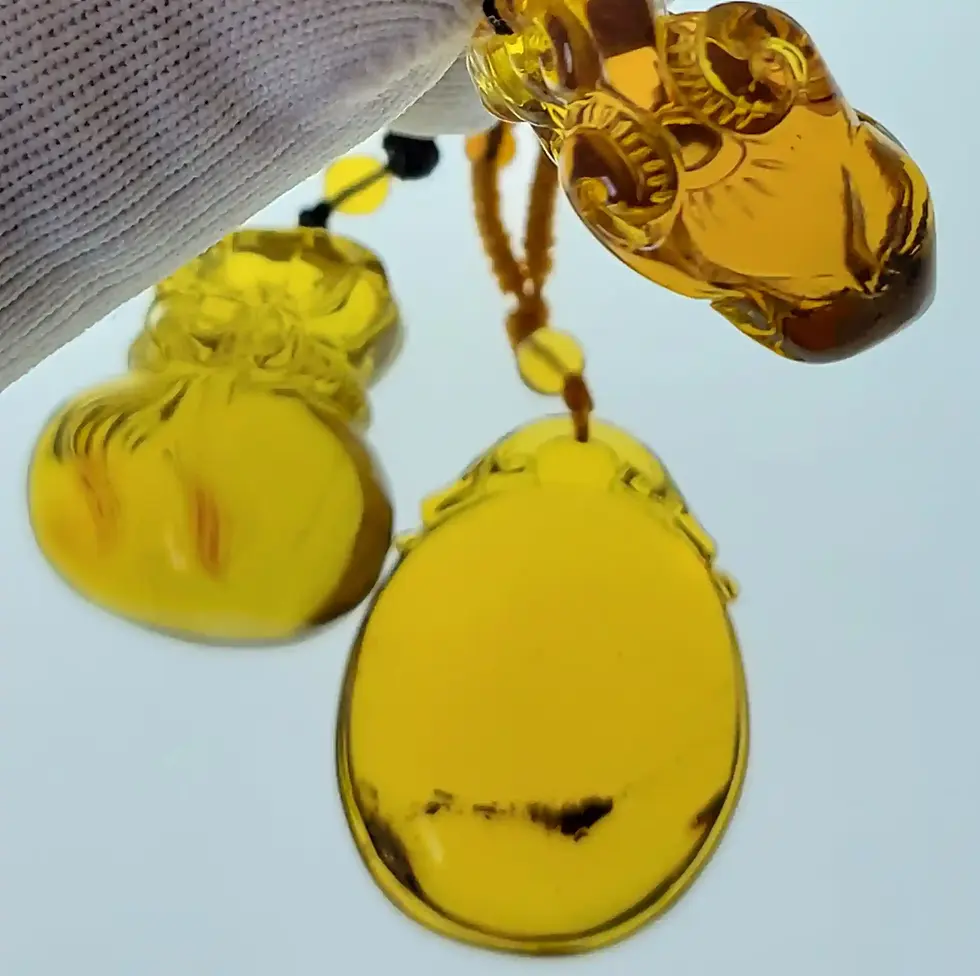3 AAA amber carvings set into necklaces 