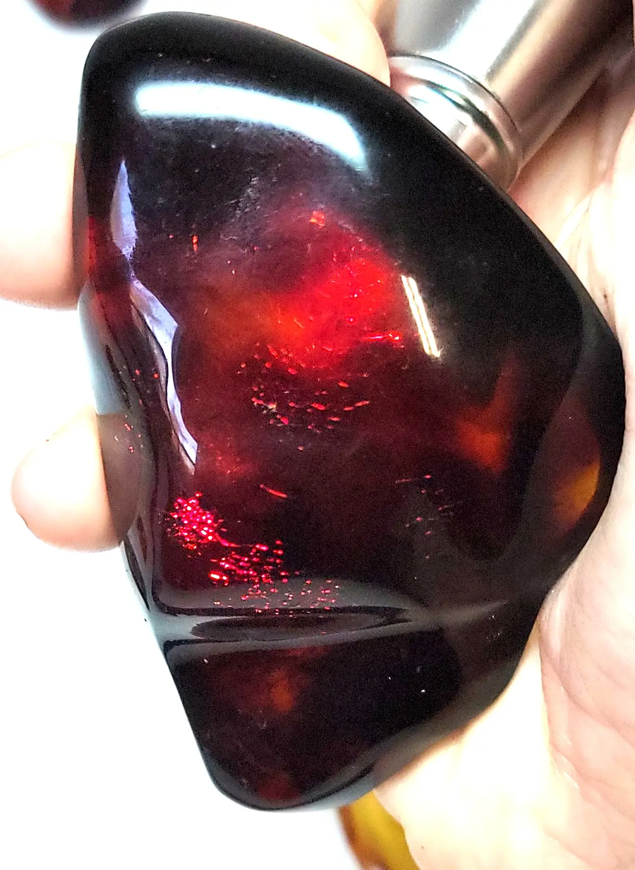 Polished red mexican amber with a flashlight behind it