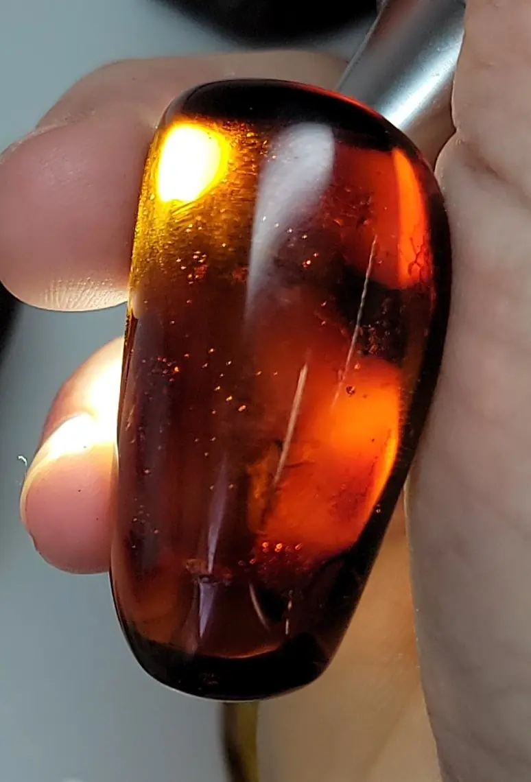 Red Mexican Amber reacting under a flashlight