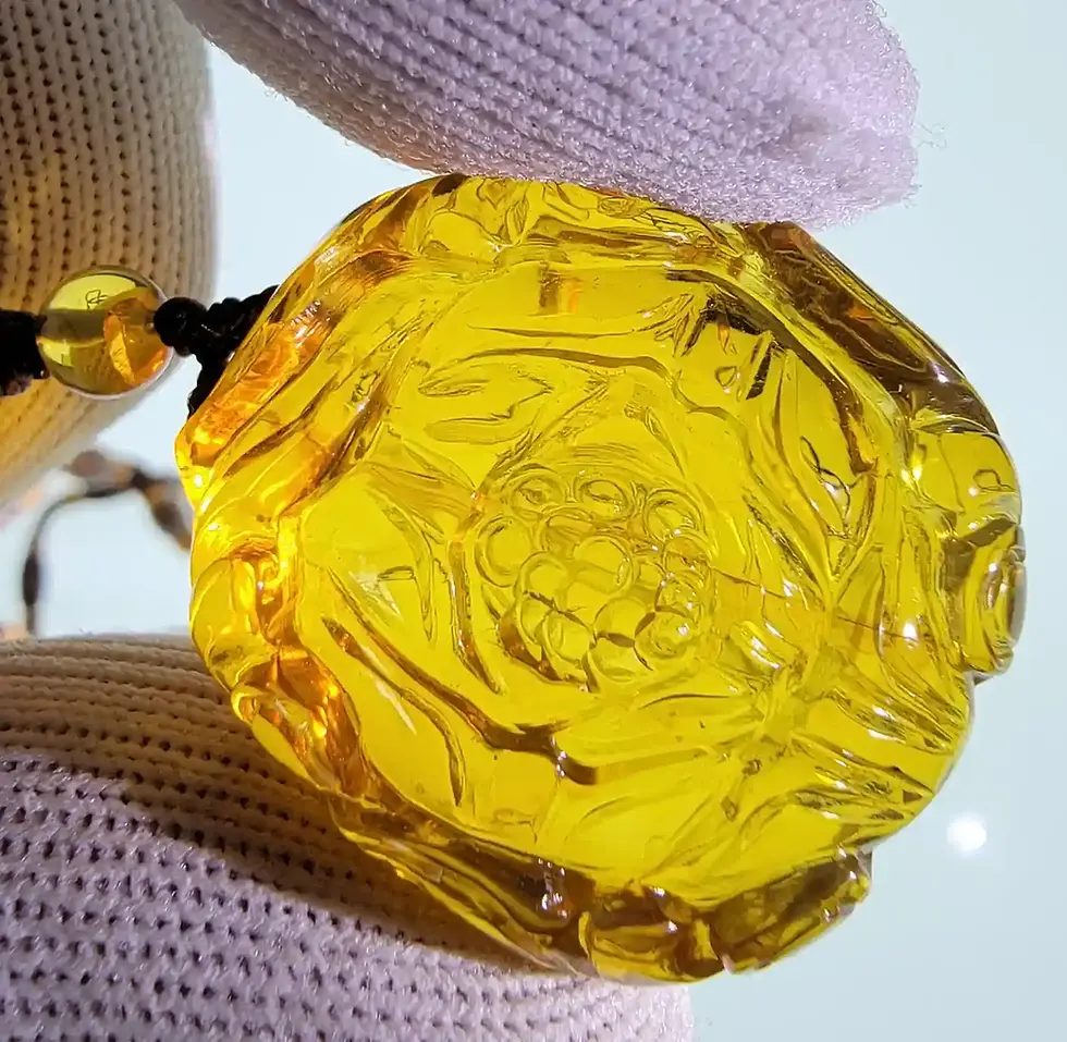Intricate amber figurine necklace in Burmese amber