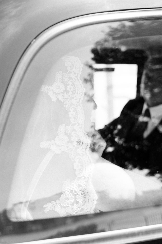 fine art wedding photo of a bride in the car in black and white in an editorial style by desiree a north photography