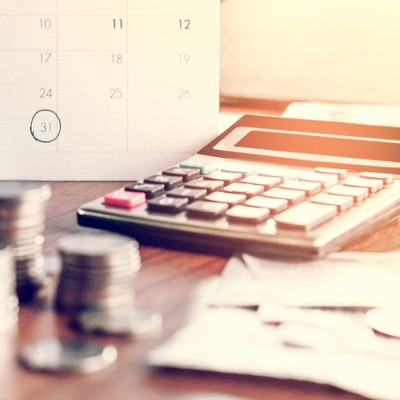 Calculator, calendar, and coins for budgeting