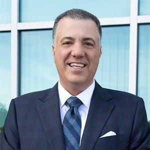 Professional man smiles in a suit and tie