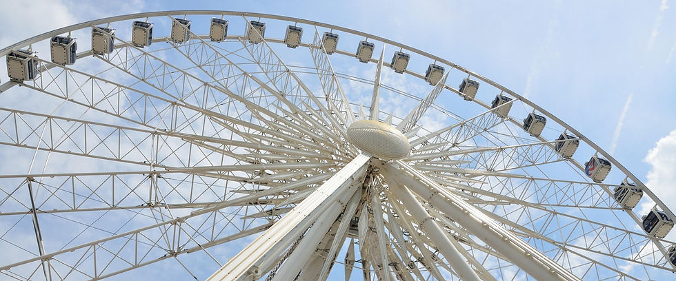 White Ferris wheel against a blue sky