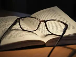 a pair of reading glasses on a book
