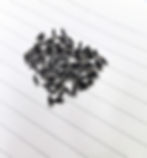 a pile of silver screws with black plastic wrapped around
