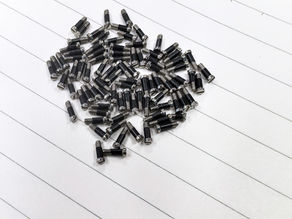 a pile of plastic-wrapped eyewear screws for premiunm eyewear