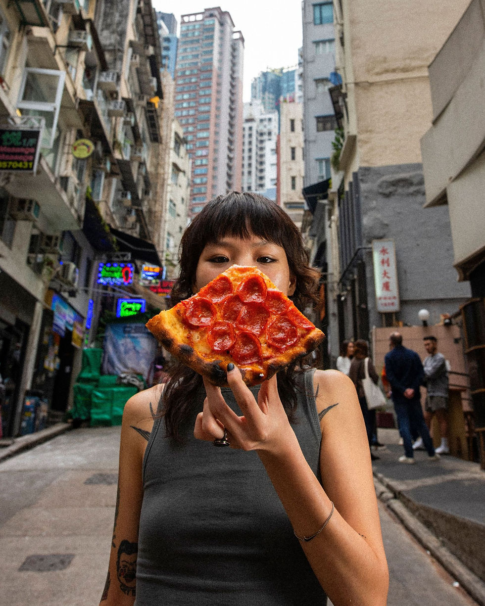 A girl eating pizza in Soho Central