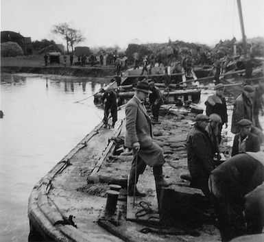 Filling barges with sandbags
