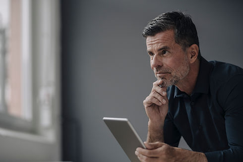 portrait-of-mature-businessman-holding-tablet-2022-03-08-01-25-59-utc.jpg