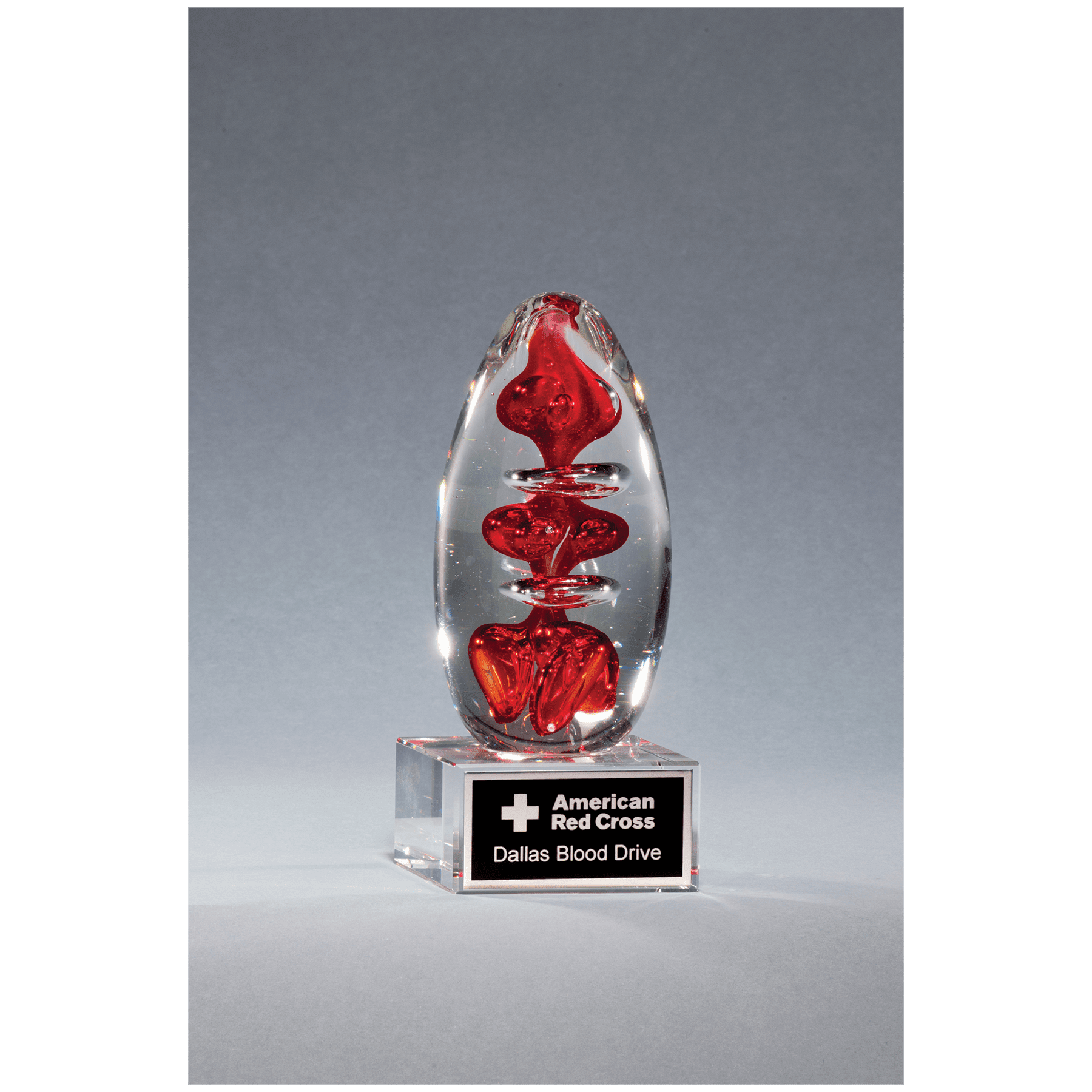 5.25” Red Egg Art Glass on Clear Base with Black Aluminum Plate