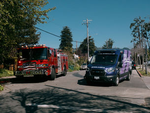 Royal Ambulance BLS unit parked alongside Berkeley Fire engine on a residential street, representing partnership in Berkeley’s 911 system