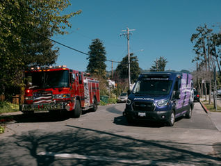 Royal Ambulance BLS unit parked alongside Berkeley Fire engine on a residential street, representing partnership in Berkeley’s 911 system