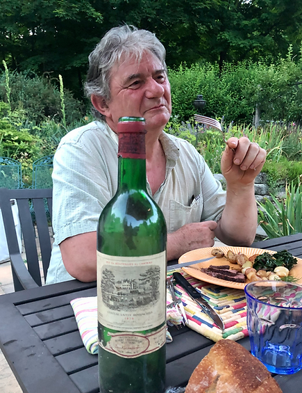 Chef AlexG enjoying an outdoor meal with a good bottle of wine