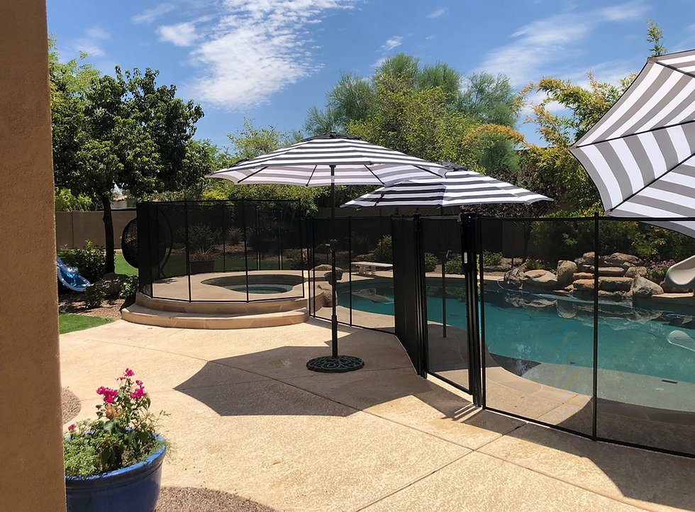Eye-level view of a mesh pool fence surrounding a swimming pool