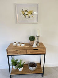 Small console table with decorative items in hallway