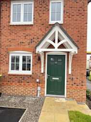 Exterior view of brick property front door and porch