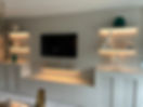 decorated living room with lit up shelves