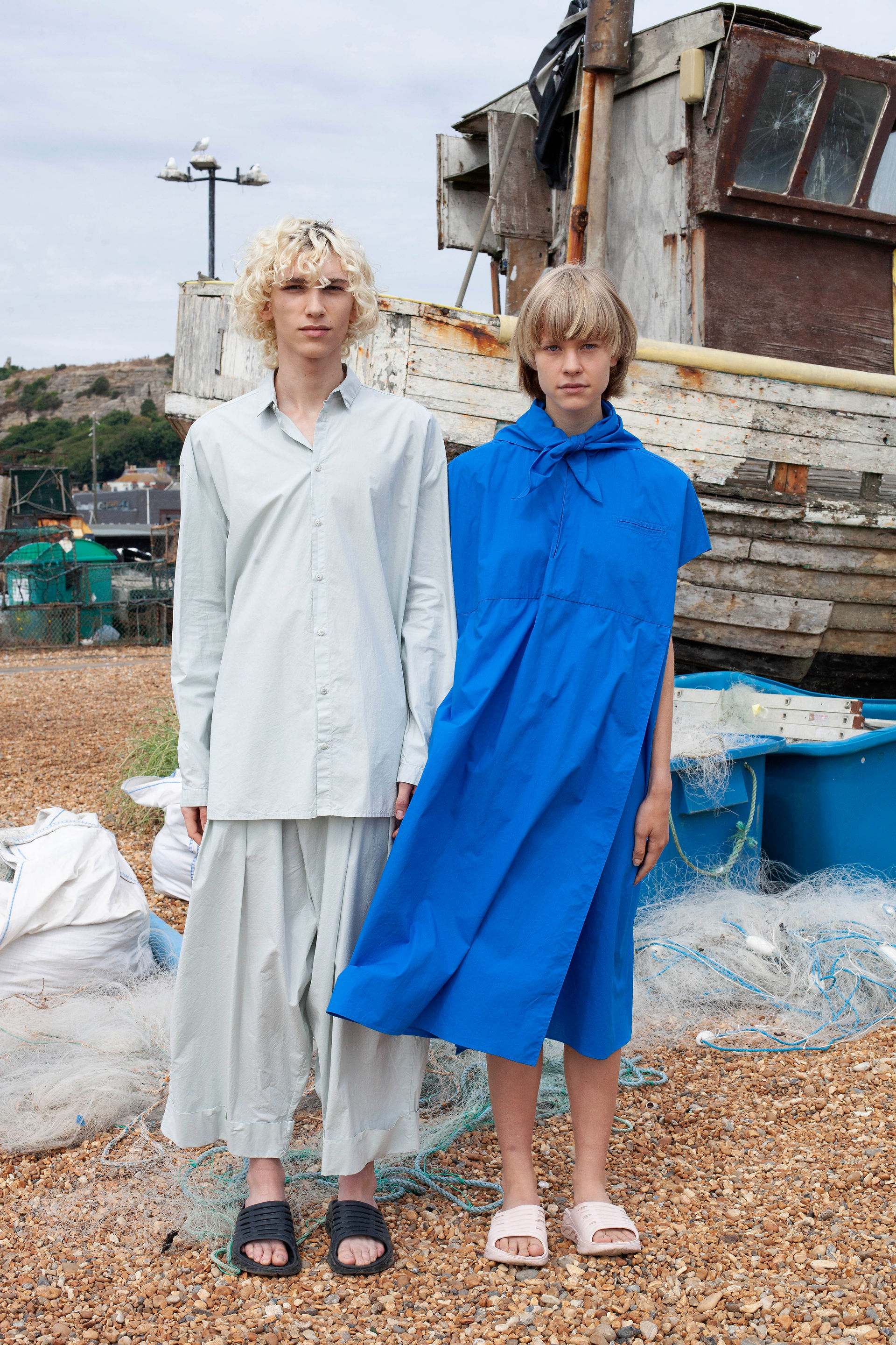 Man and a woman in cream and blue oversized fashion clothing