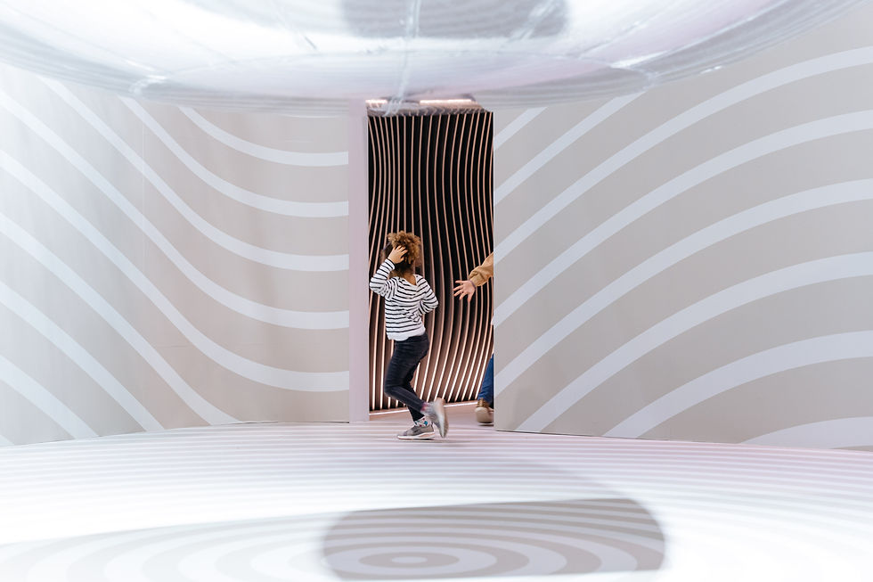 girls playing at exhibit booth designed by Alessandro Munge for luxury quartz brand Caesarstone