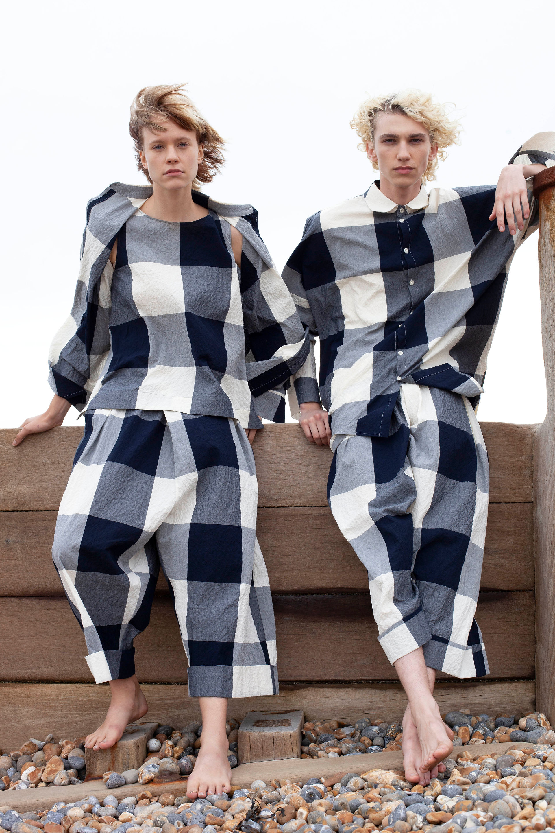 Man and a woman in gingham oversized fashion clothing