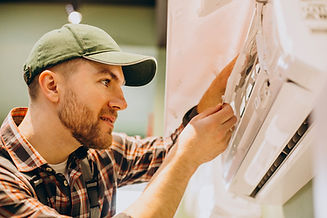 repairman-doing-air-conditioner-service.jpg