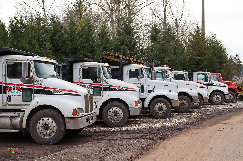 An array of S&H Recycling trucks on the lot