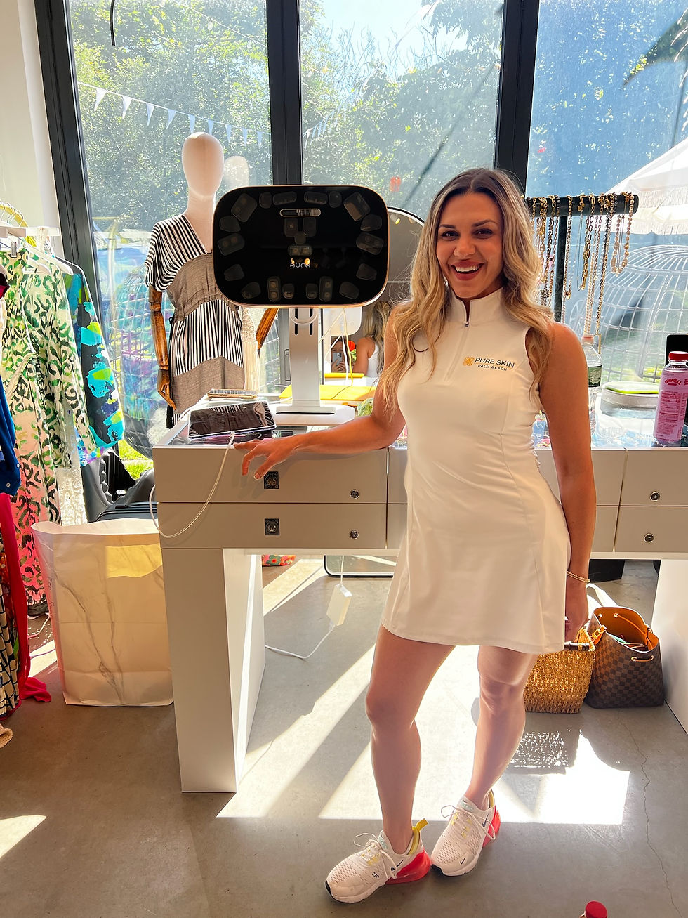 Woman poses indoors besides a medical device