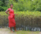 Woman standing next to mangrove saplings in Nigeria