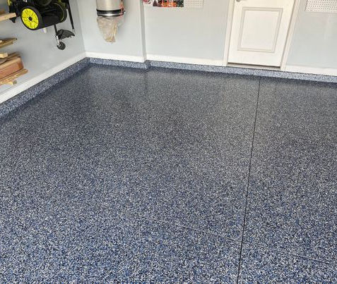 Orbit Flake Blend Garage Floor: Transform your garage with our Orbit flake blend epoxy flooring, featuring a dynamic mix of black, white, and silver flakes that create a striking and modern surface, perfect for enhancing both style and durability.