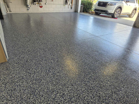Orbit Garage Flooring Polyaspartic Coating in Central Florida with white car in background