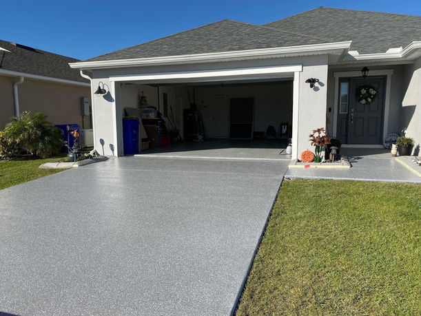 Polyaspartic Coatings Driveway Resurfacing Final Photo. The flake system on the driveway gives it a grey sleek look