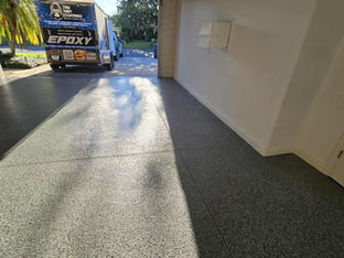 Nightfall Polyaspartic Garage Flooring in Central Florida with a trailer in the back