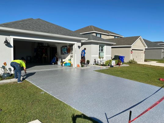 Polyaspartic Coatings Driveway Resurfacing with workers in the background