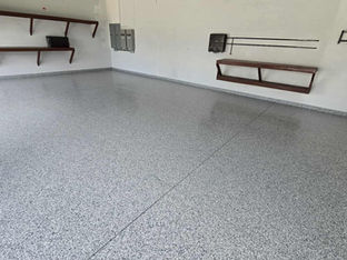 Gravel Polyaspartic Flooring Garage Coatings In Central Florida With Wood Shelving on White Walls Left SIde
