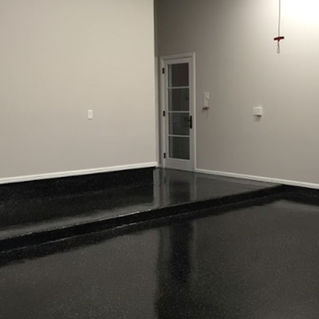 Enhance your garage with a solid black epoxy floor by Tru-Grit Garage Flooring. Imagine a flawless black epoxy surface that is both visually striking and highly functional. Tru-Grit's attention to detail and commitment to quality make their epoxy floors a reliable choice for any garage setting.