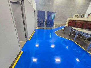 Empty industrial facility featuring a blue epoxy safety sidewalk with yellow borders.