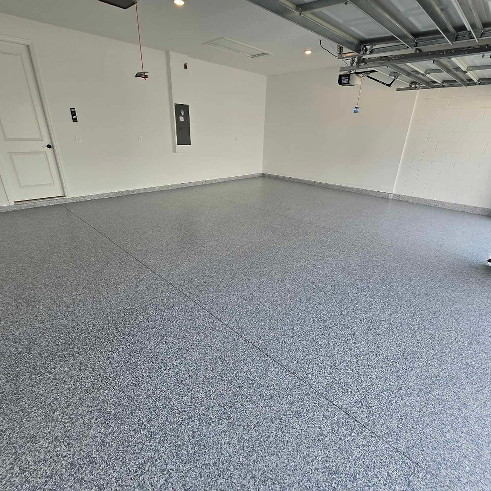 Empty garage with a gray speckled floor, white walls, and an open garage door. Overhead lights and a red pull cord are visible.