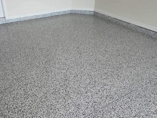 Domino Flake Blend Garage Transformation: Elevate your garage with our Domino flake blend, showcasing a bold blend of black, white, and gray tones that provide a sleek and contemporary look, ensuring a visually appealing and long-lasting surface.